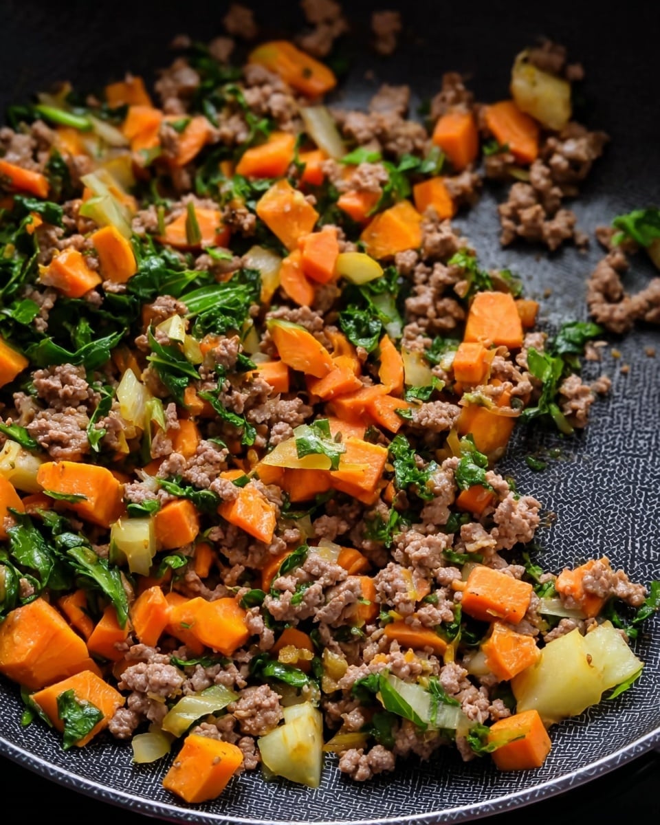 The image shows a close-up view of a pan with cooked ground meat, bright orange carrot pieces, small green leafy vegetable pieces, and light yellow chunks of another vegetable, all mixed together. The ground meat is brown and crumbly, spread evenly throughout the pan. The carrots are cut into small cubes and sticks, sitting on top and mixed in with the meat. The green leafy pieces add a fresh contrast, scattered across the meat and carrots. The light yellow vegetable chunks add another layer of color and texture, scattered throughout the pan as well. The inside of the pan has a dark non-stick textured surface. Photo taken with an iphone --ar 4:5 --v 7
